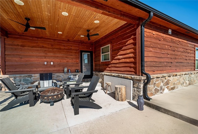 view of patio / terrace with ceiling fan and a fire pit