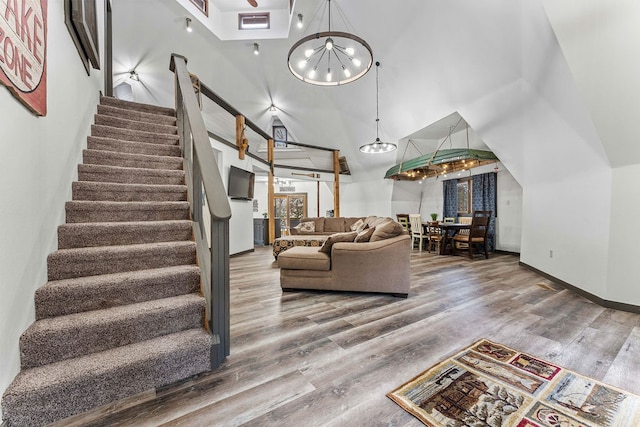 living room featuring a chandelier, hardwood / wood-style floors, and a high ceiling