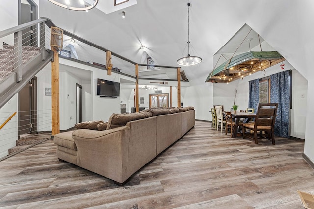 living room with hardwood / wood-style flooring and a towering ceiling