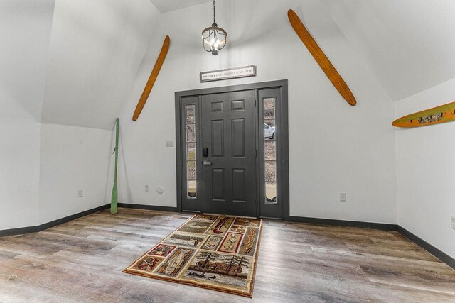 entrance foyer featuring beam ceiling, hardwood / wood-style flooring, and high vaulted ceiling