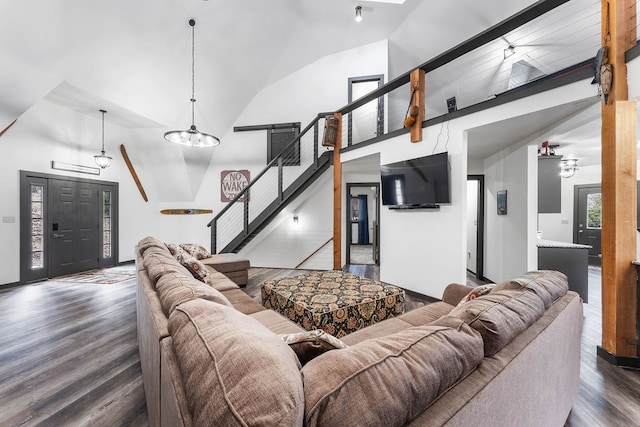 living room with dark wood-type flooring and vaulted ceiling