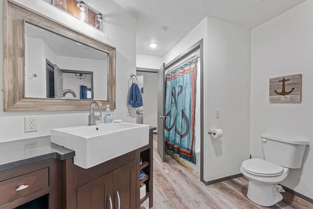 bathroom featuring vanity, toilet, a shower with curtain, and hardwood / wood-style floors