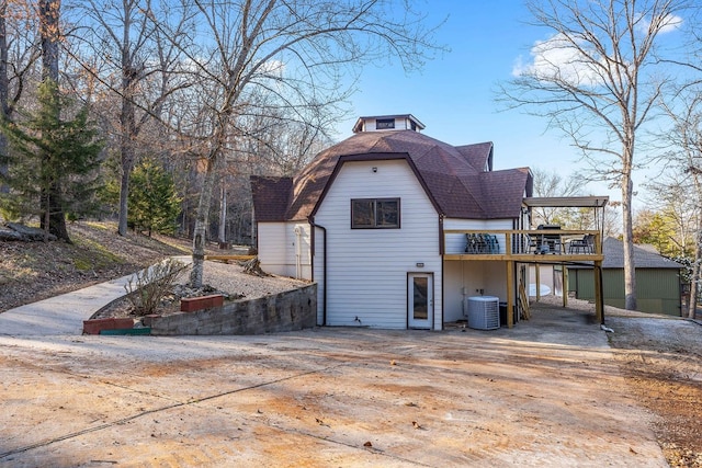 view of side of home with central AC and a garage