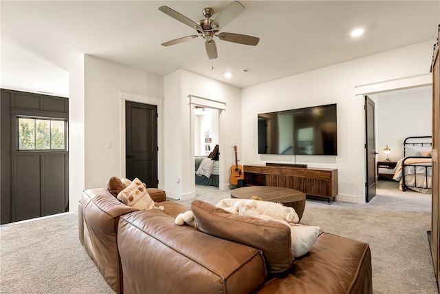 living room with light carpet and ceiling fan