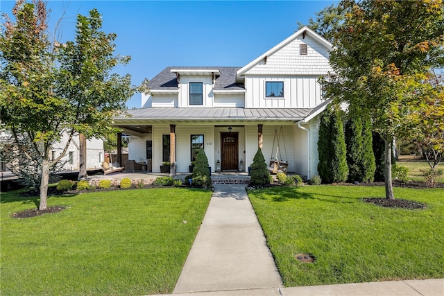 view of front of home with covered porch and a front lawn