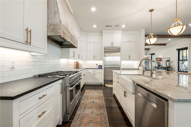 kitchen with custom exhaust hood, white cabinets, hanging light fixtures, dark hardwood / wood-style flooring, and premium appliances