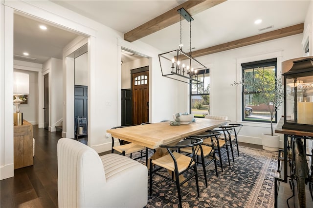 dining space featuring a notable chandelier, dark hardwood / wood-style floors, and beamed ceiling