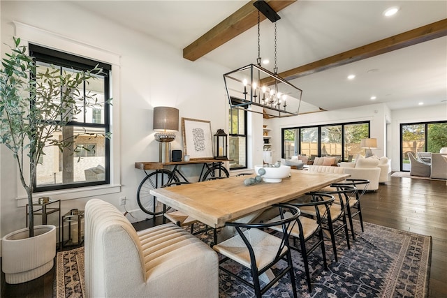 dining space with dark wood-type flooring, beamed ceiling, and a chandelier