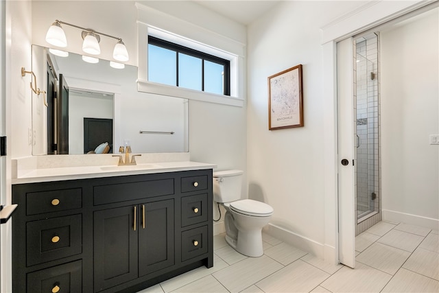 bathroom with vanity, tile patterned flooring, toilet, and an enclosed shower