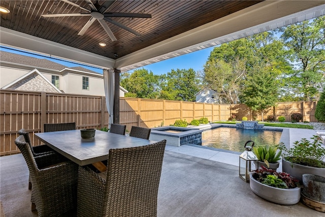 view of patio / terrace with a fenced in pool and ceiling fan