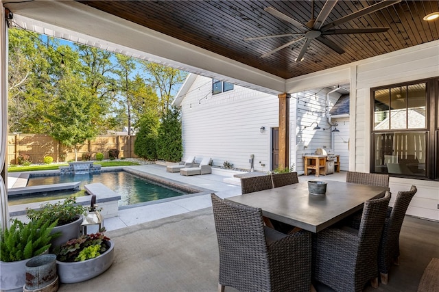 view of patio / terrace with a fenced in pool and ceiling fan