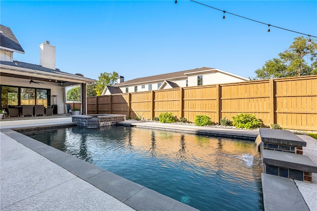 view of swimming pool featuring a patio, pool water feature, an in ground hot tub, and ceiling fan