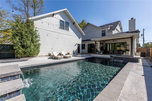 view of pool featuring an in ground hot tub, outdoor lounge area, pool water feature, a patio, and ceiling fan