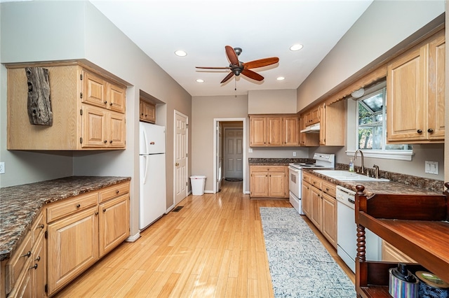 kitchen featuring ceiling fan, sink, dark stone counters, light hardwood / wood-style floors, and white appliances