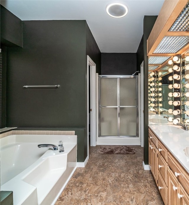 bathroom featuring vanity and independent shower and bath