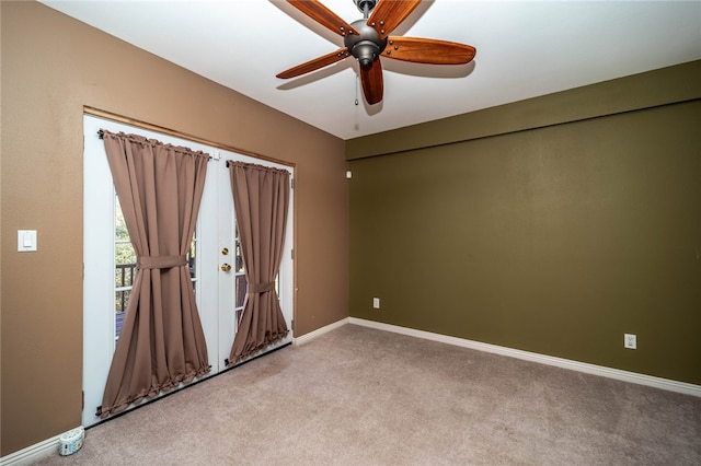 carpeted spare room featuring ceiling fan