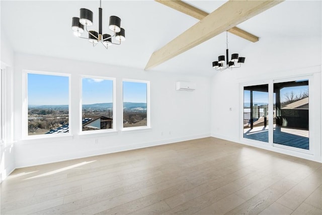 spare room featuring vaulted ceiling with beams, a notable chandelier, a mountain view, a wall mounted AC, and light wood-type flooring