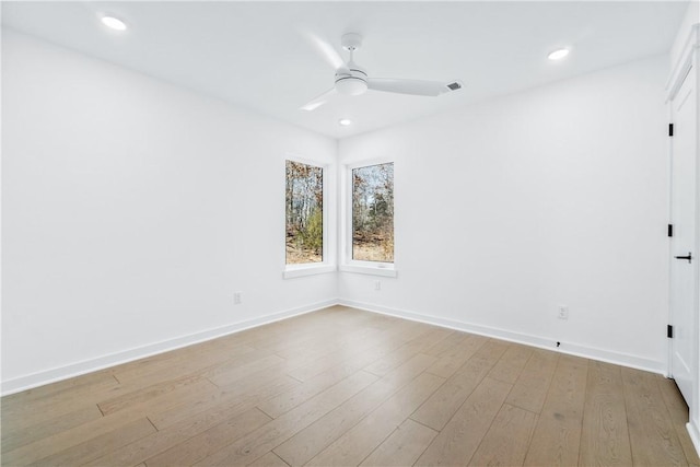 spare room featuring ceiling fan and light hardwood / wood-style floors