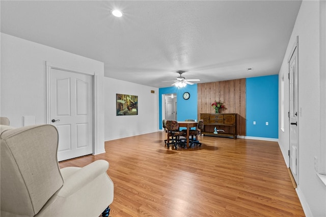 dining room featuring ceiling fan, a textured ceiling, and hardwood / wood-style floors