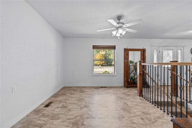 unfurnished room with ceiling fan