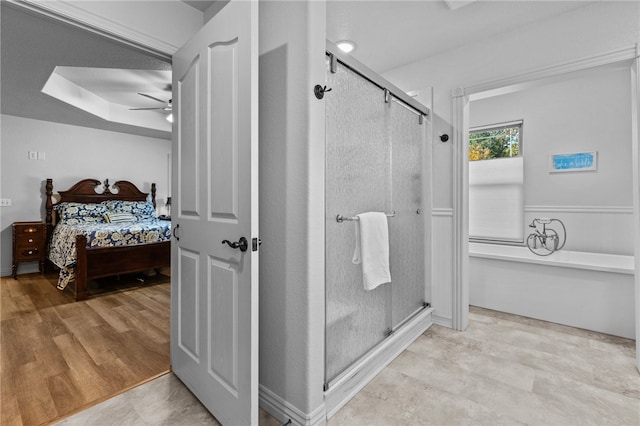 bathroom with an enclosed shower, hardwood / wood-style flooring, and ceiling fan