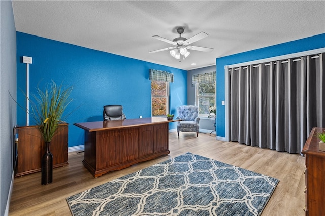 office area with hardwood / wood-style floors, a textured ceiling, and ceiling fan