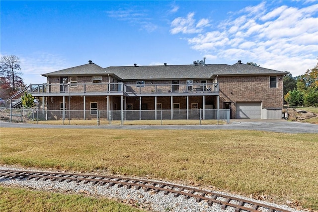 9299 W Forest Hills Dr, Fayetteville, AR 72704 - rear view of property featuring brick siding, driveway, a garage, and a deck