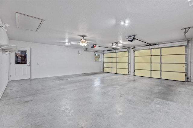 garage with ceiling fan and a garage door opener