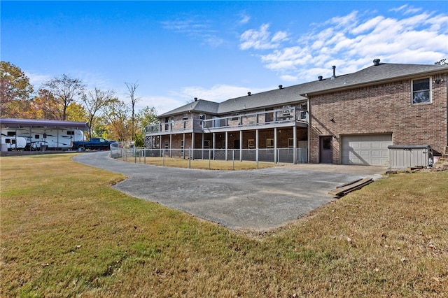 back of house with a yard and a garage