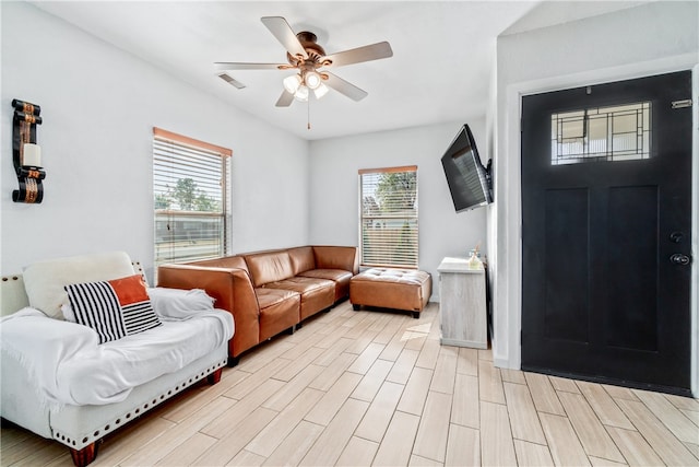 living room featuring ceiling fan and light wood-type flooring