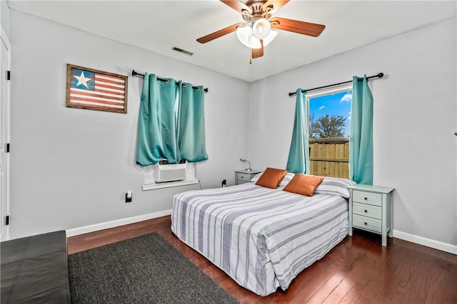 bedroom with cooling unit, dark hardwood / wood-style floors, and ceiling fan