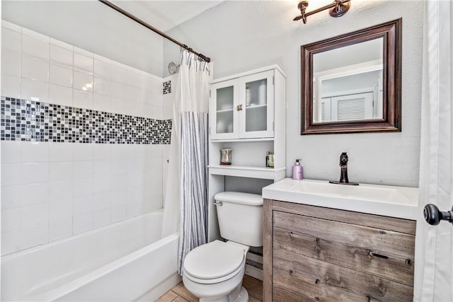 full bathroom featuring vanity, shower / tub combo, and toilet