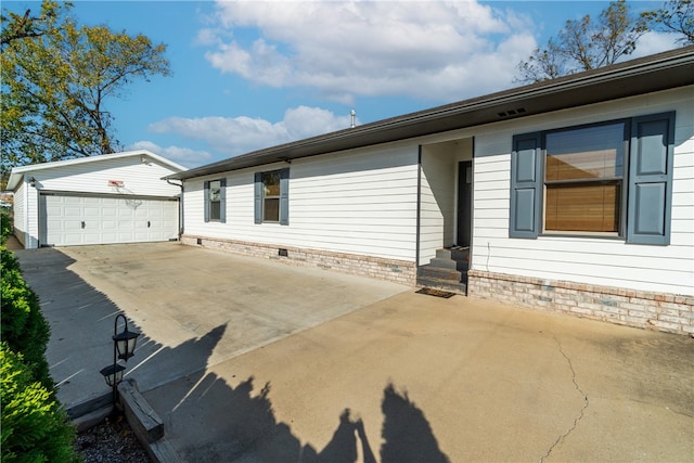 view of property exterior with an outdoor structure and a garage