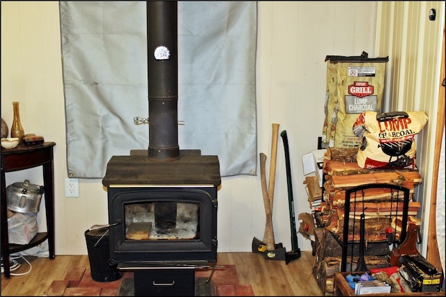 interior details with a wood stove and hardwood / wood-style flooring