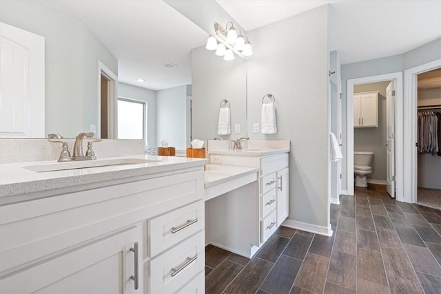 bathroom featuring vanity and toilet