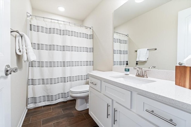 bathroom featuring vanity, toilet, and walk in shower