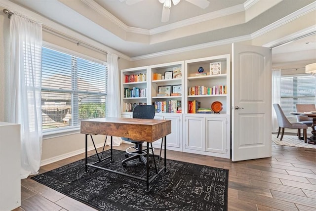 office area with ornamental molding, a wealth of natural light, ceiling fan, and a tray ceiling