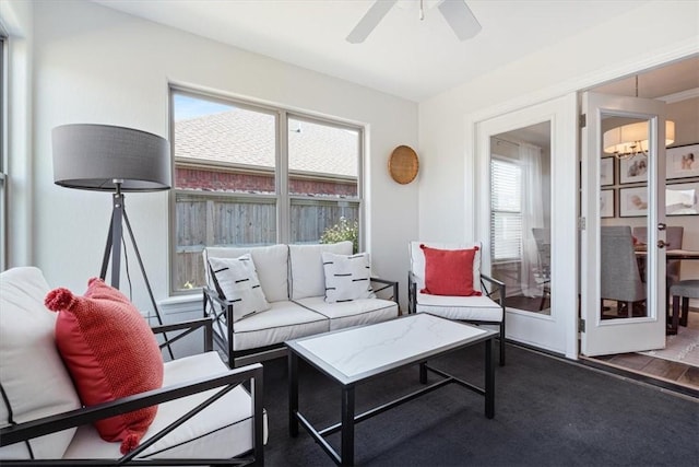 sunroom featuring plenty of natural light and ceiling fan with notable chandelier