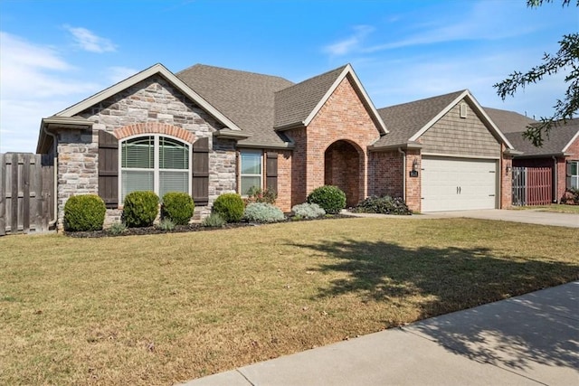 view of front of home featuring a garage and a front lawn