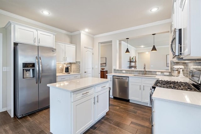 kitchen with white cabinetry, appliances with stainless steel finishes, kitchen peninsula, and sink