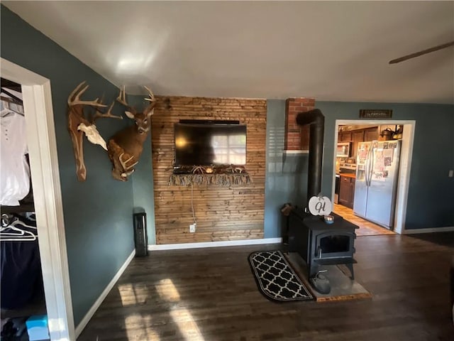 52720 S 680, Colcord, OK 74338 - living area featuring a wood stove, baseboards, and wood finished floors