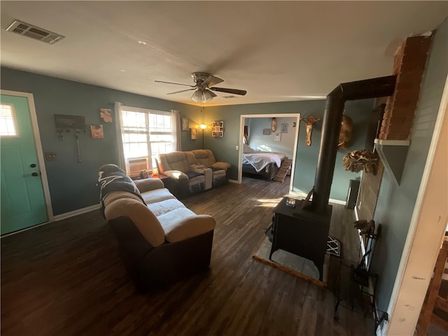 living room featuring ceiling fan and dark hardwood / wood-style floors