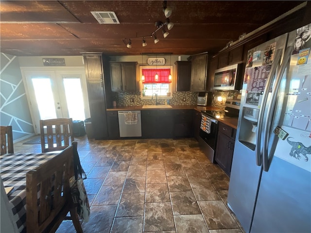 kitchen with decorative backsplash, stainless steel appliances, french doors, and plenty of natural light