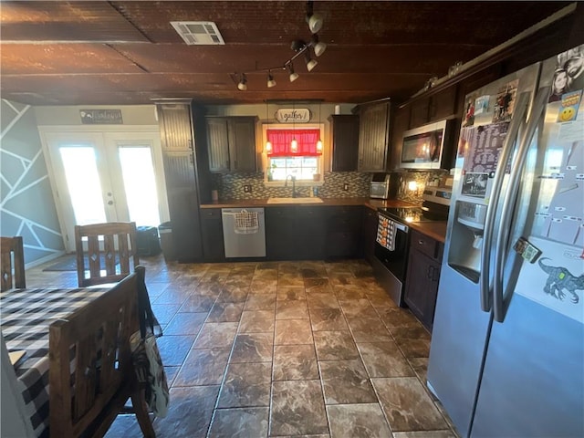 52720 S 680, Colcord, OK 74338 - kitchen with stainless steel appliances, a sink, backsplash, french doors, and dark countertops