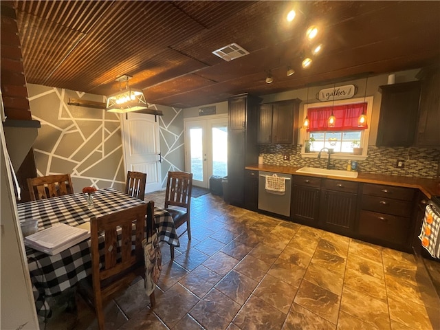 kitchen with backsplash, dishwasher, sink, french doors, and decorative light fixtures