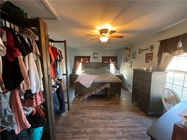 bedroom with ceiling fan and dark hardwood / wood-style floors