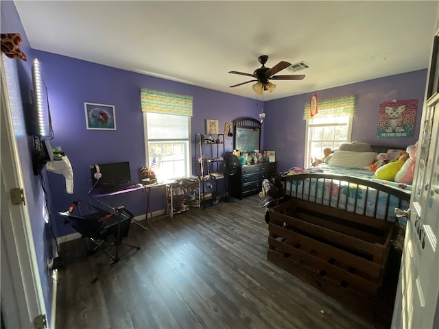 bedroom with ceiling fan and dark hardwood / wood-style flooring