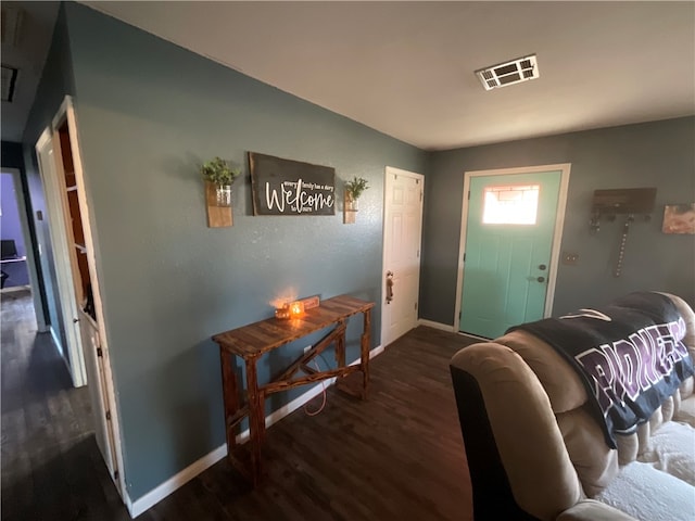 entryway with dark hardwood / wood-style flooring