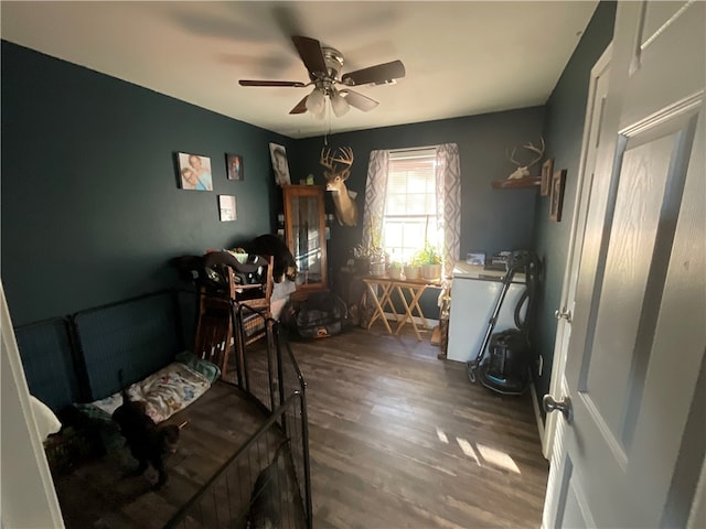 interior space with ceiling fan and dark hardwood / wood-style flooring