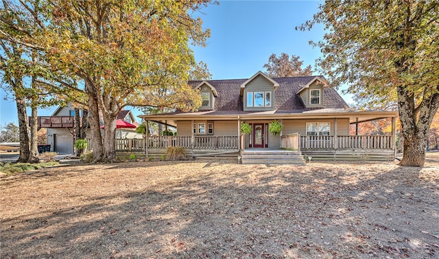 farmhouse inspired home with a porch and a garage